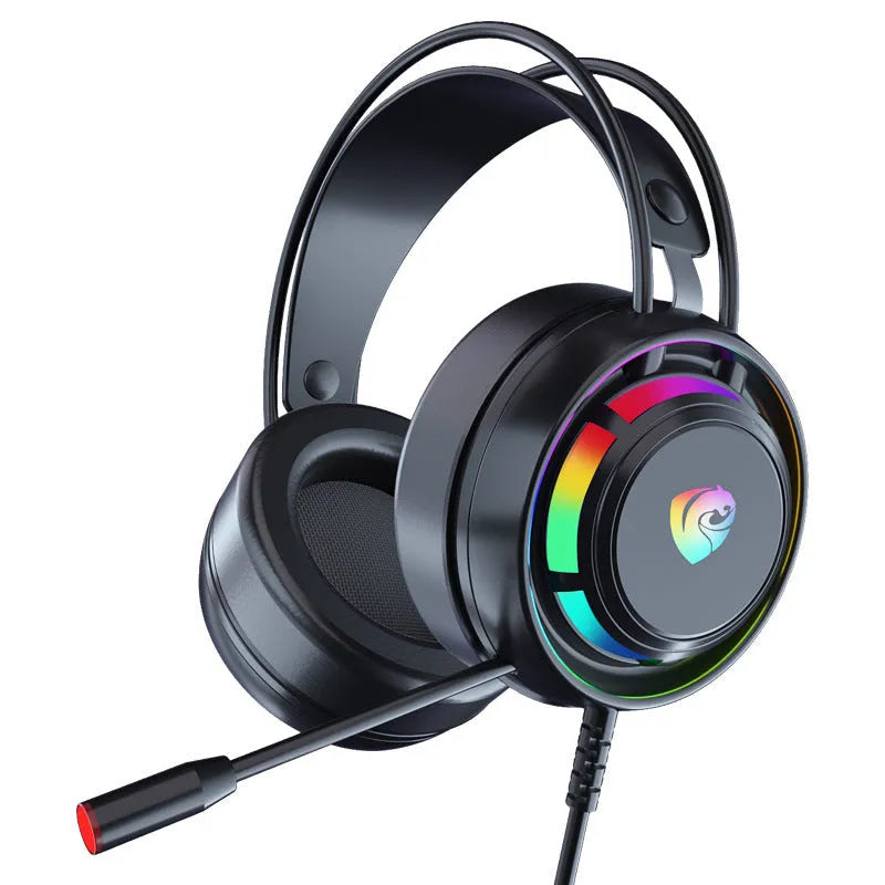 Black wired gaming headset with microphone, adjustable headband, and large circular ear cups on a desk.