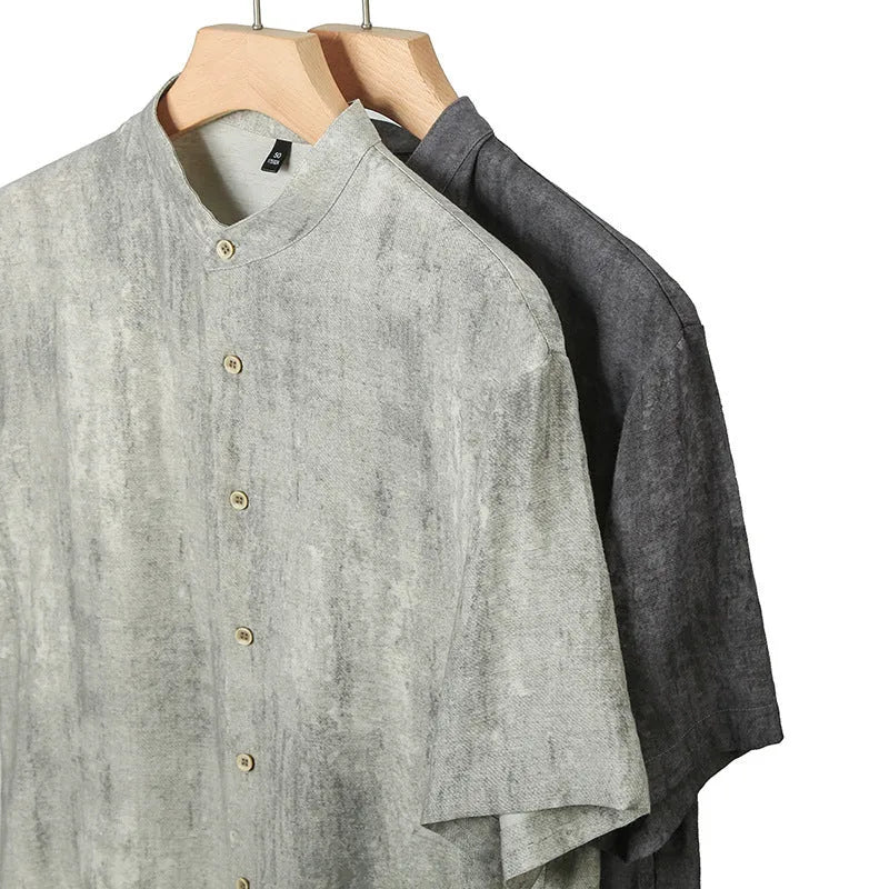 Man wearing a grey loose-fit linen blend cardigan shirt with a stand collar.