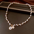 Gold-plated necklace with round pearl pendant and zircon accents on adjustable chain