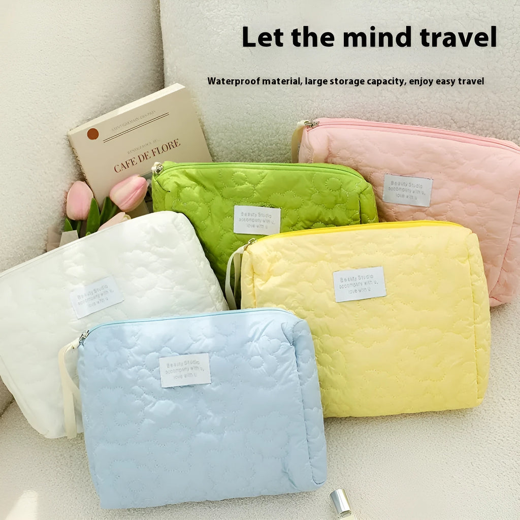 Silk quilted cosmetic storage bag for women shown in a candy colour, with a quilted pattern and zip closure.