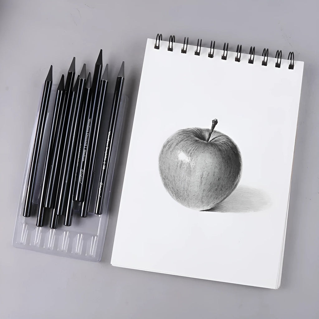 Set of nine wooden drawing pencils, six graphite and three carbonized, on a suction card.