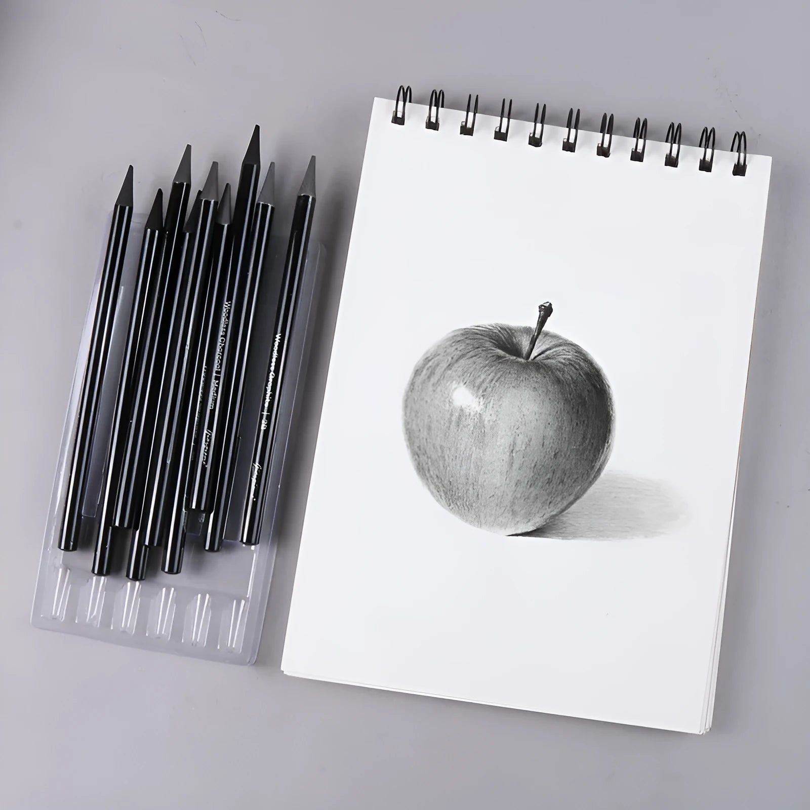 Set of nine wooden drawing pencils, six graphite and three carbonized, on a suction card.