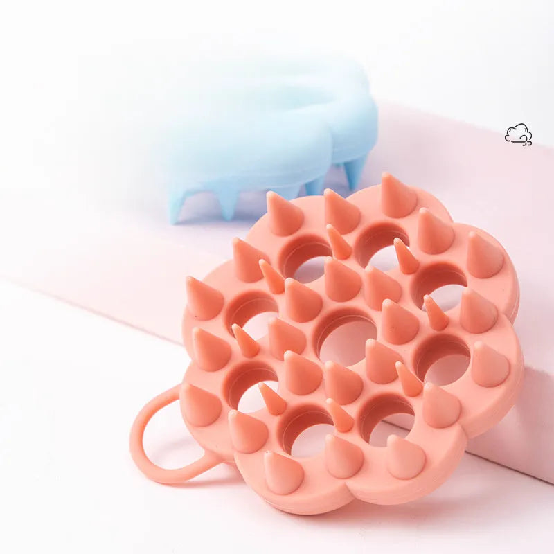 Handheld silicone pet grooming brush for wet and dry use, shown in assorted colours.