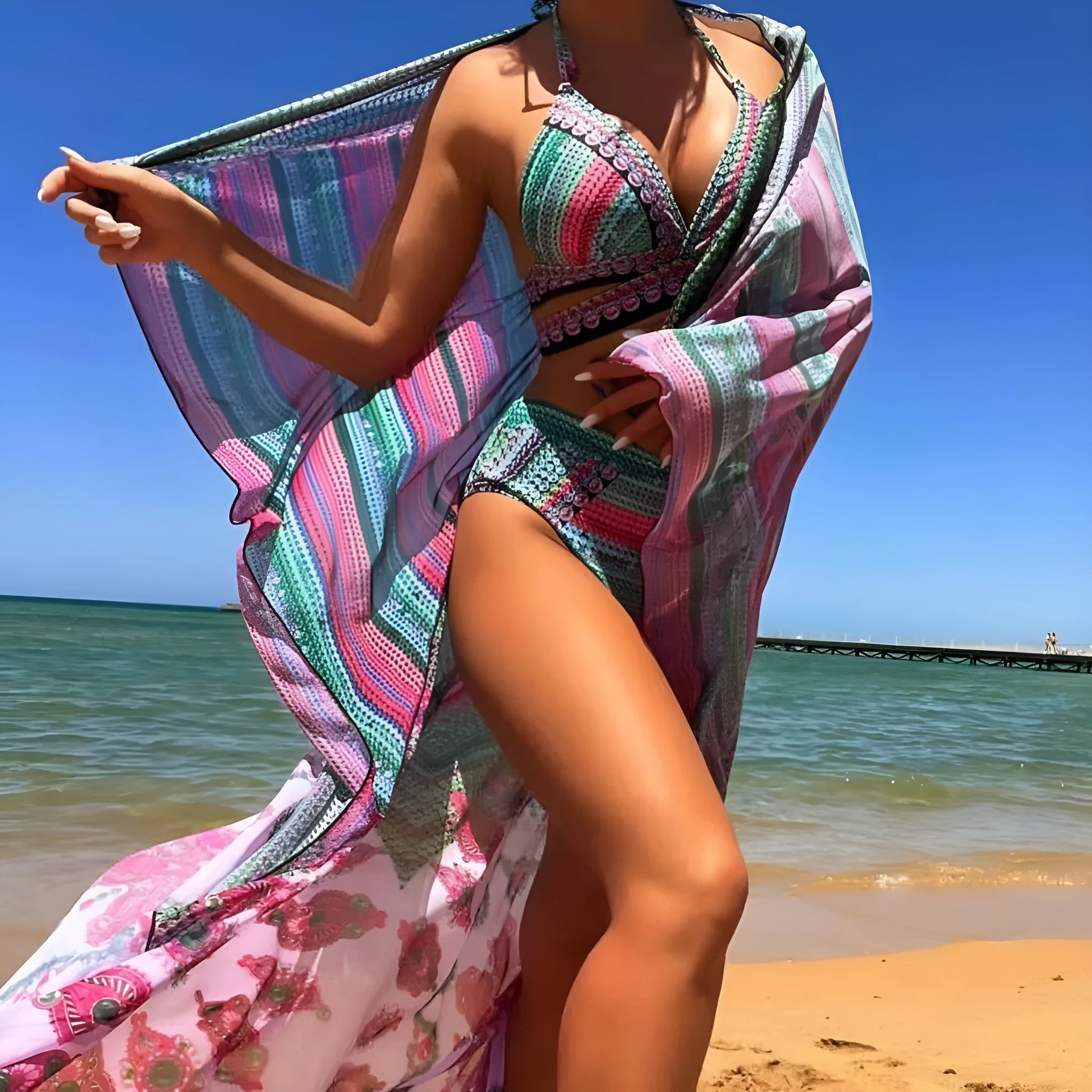 Women's blue three-piece bikini set with cross bandage bra, high-waisted briefs, and a matching smock.