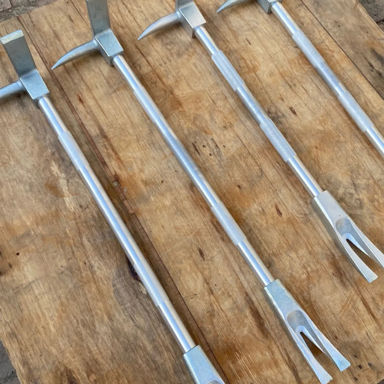 Silver carbon steel wrecking bar 24 inches 61cm multifunctional fire breaking tool on plain background