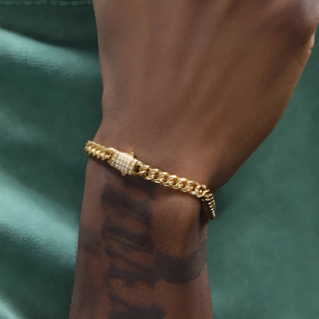 8mm gold titanium steel Cuban bracelet on display with alloy gemstone inlay