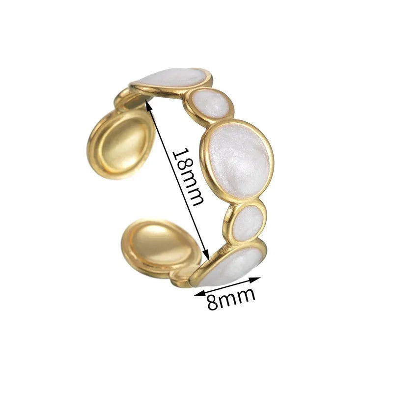 Silver geometric ring with adjustable opening on a plain background.