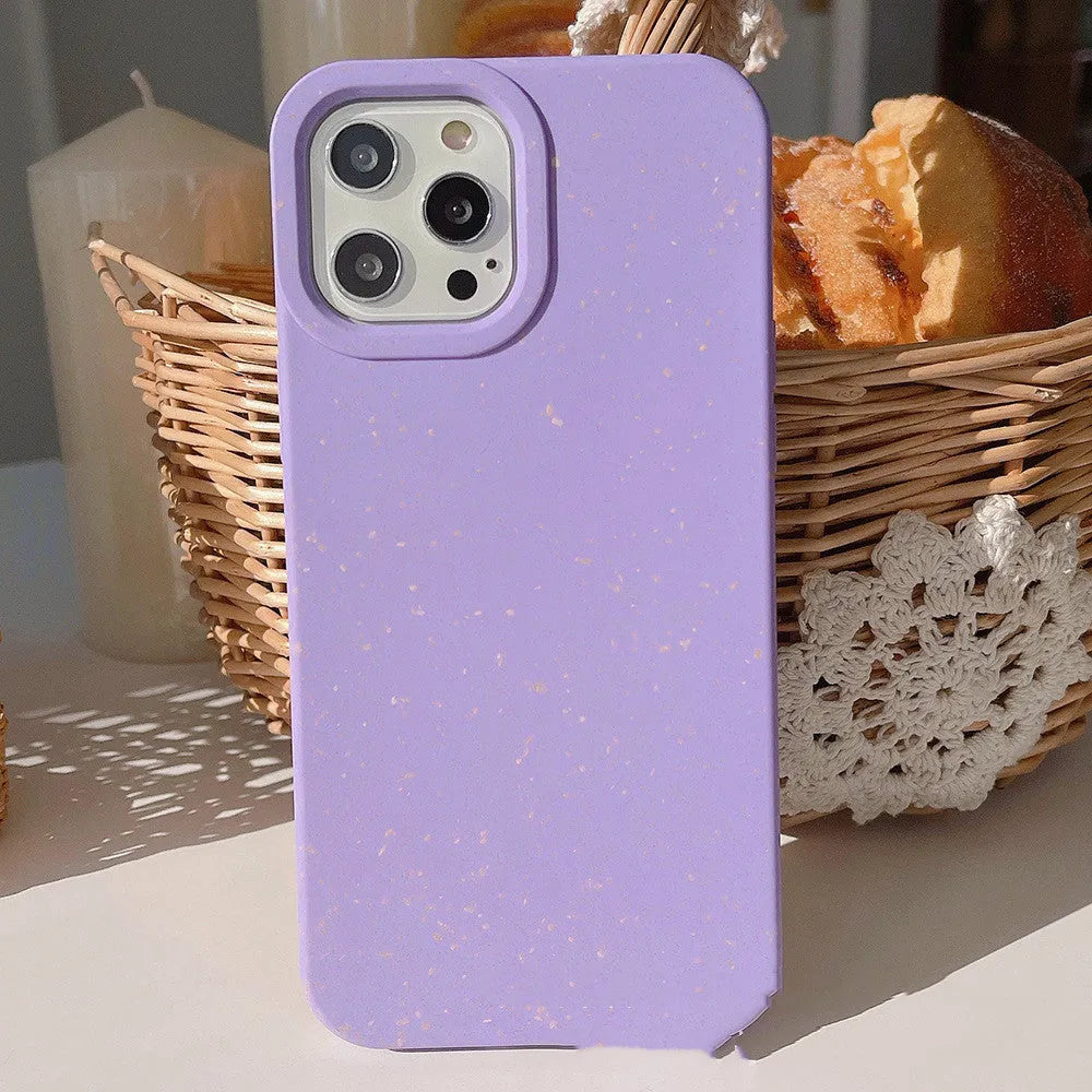 Biodegradable wheat straw mobile phone case for iPhone in seven colour options on a table.