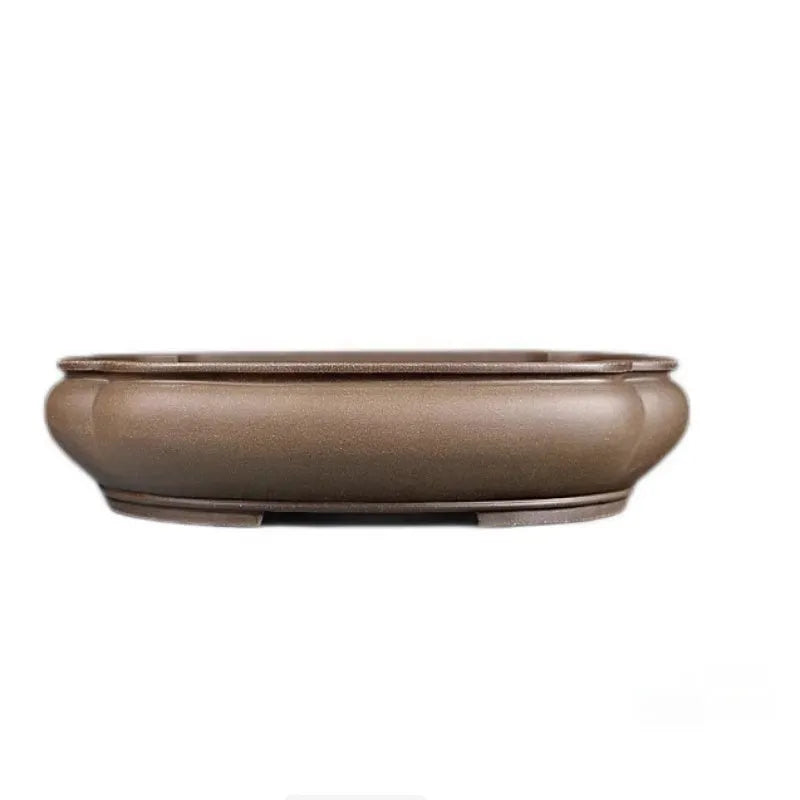 Handmade antique papaya-shaped purple clay flower pot shown from the side.