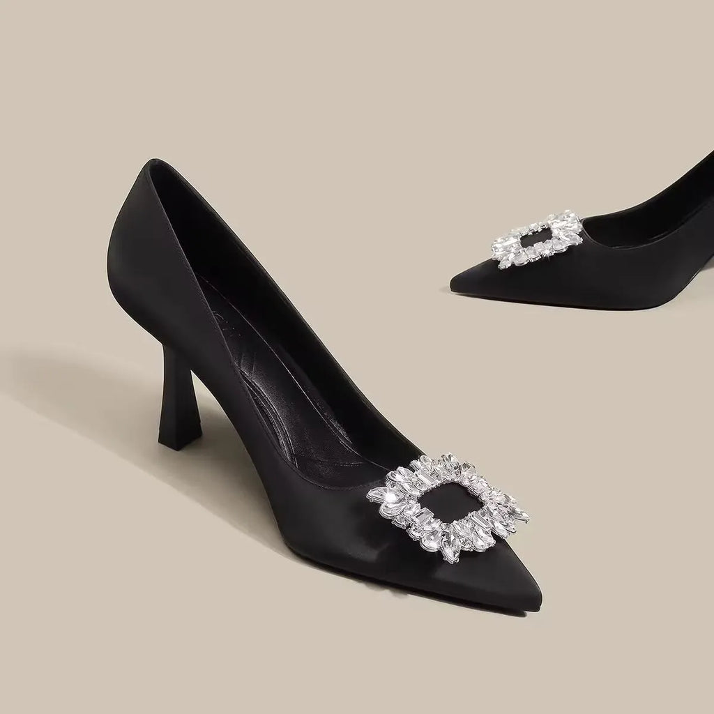 Women's creamy-white pointed toe stiletto high heels with a mid-height heel on a plain background.