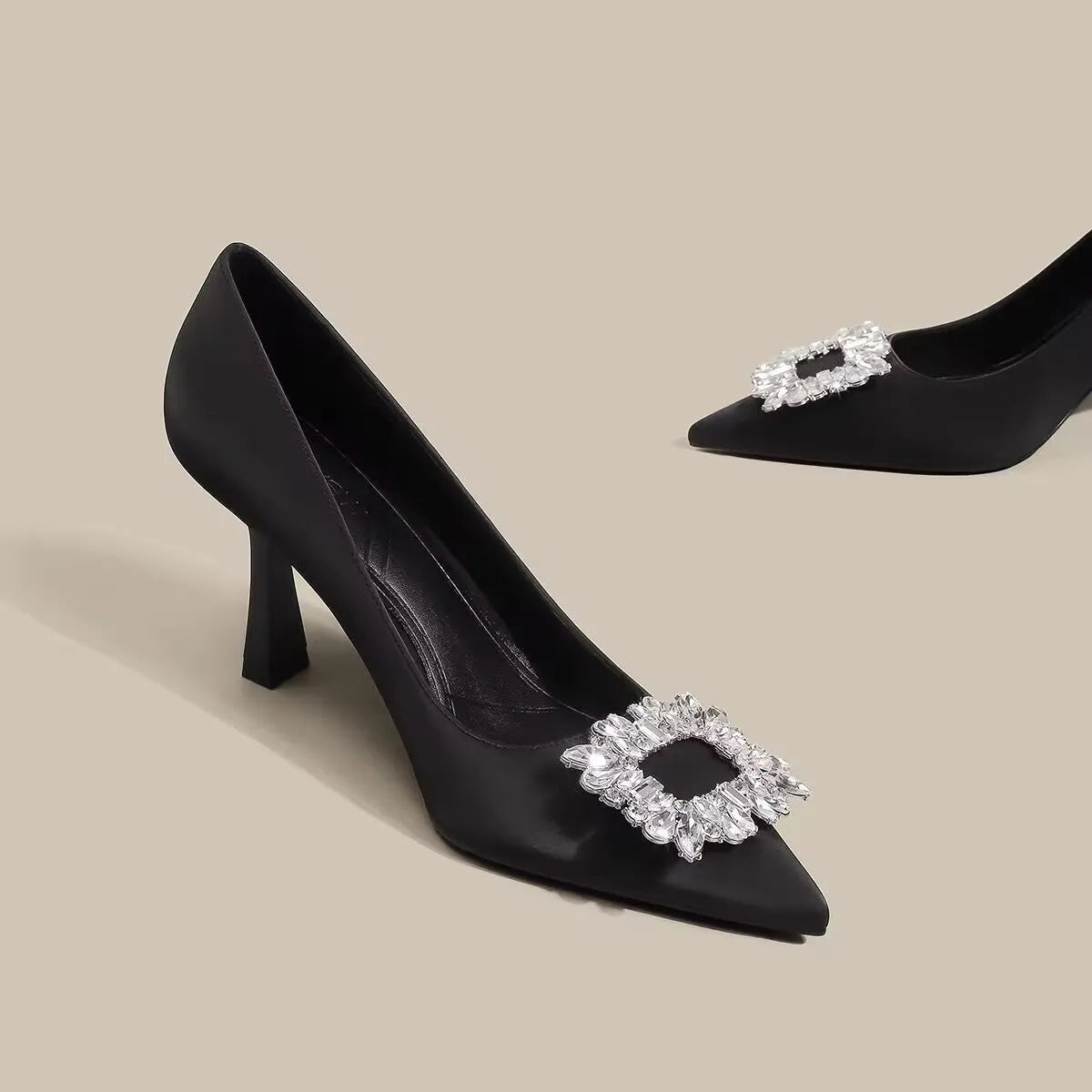 Women's creamy-white pointed toe stiletto high heels with a mid-height heel on a plain background.