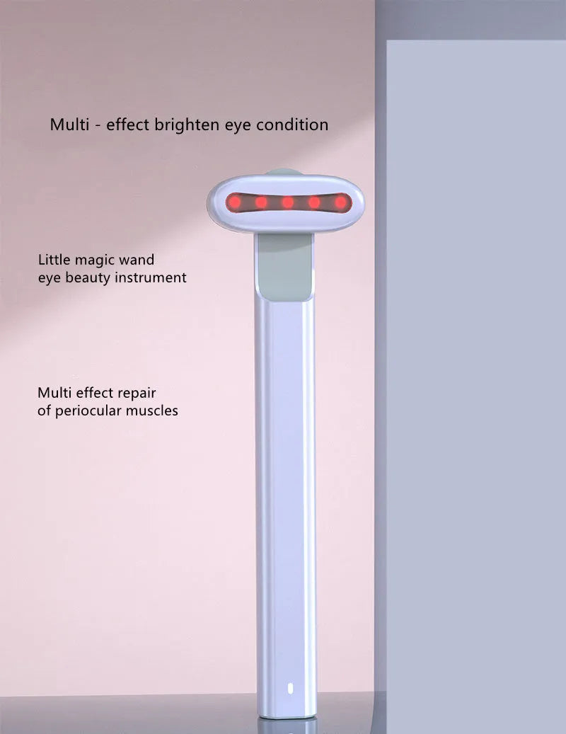 Micro current introduction eye massage instrument in green, with RF gear and USB charging cable on a white background