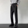 Men's apricot and black straight-leg suit trousers laid flat, showing loose fit and formal design.
