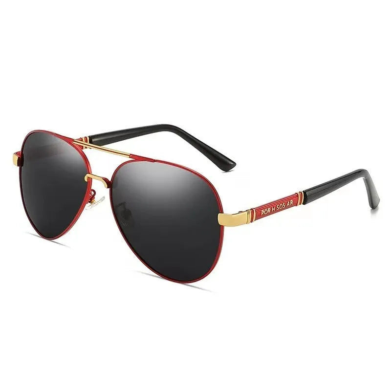 Gold metal frame sunglasses with polarised grey lenses and dragon phoenix temple detail on a table.
