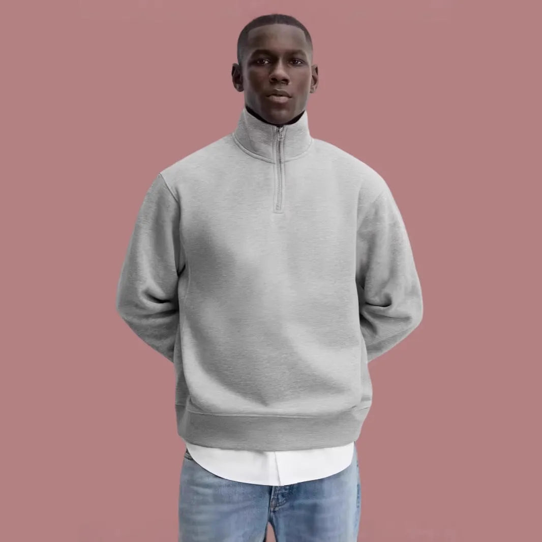 Grey half-zip cotton hoodie with a stand collar, shown on a model.