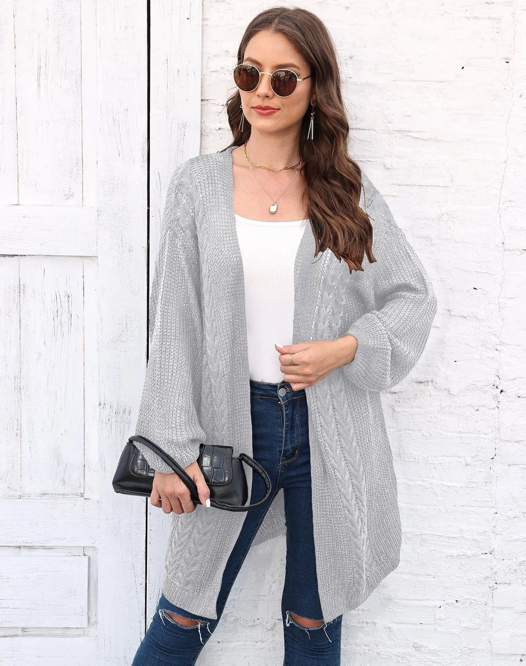 Women's loose longline acrylic cardigan sweater coat in a solid colour.