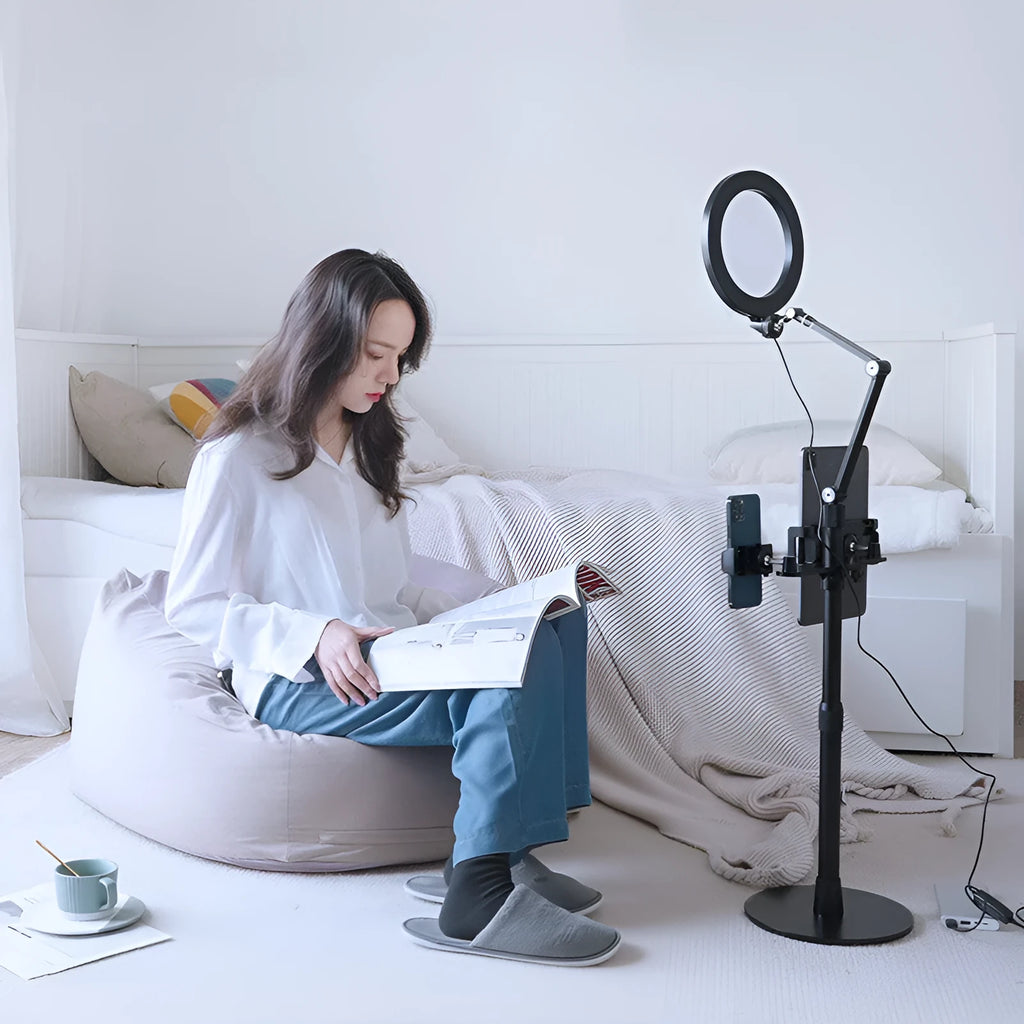 Black mobile phone tablet stand with fill light attachment in folded position showing rotation mechanism