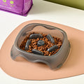 Blue plastic dog slow feeder anti-choking bowl on a white background.