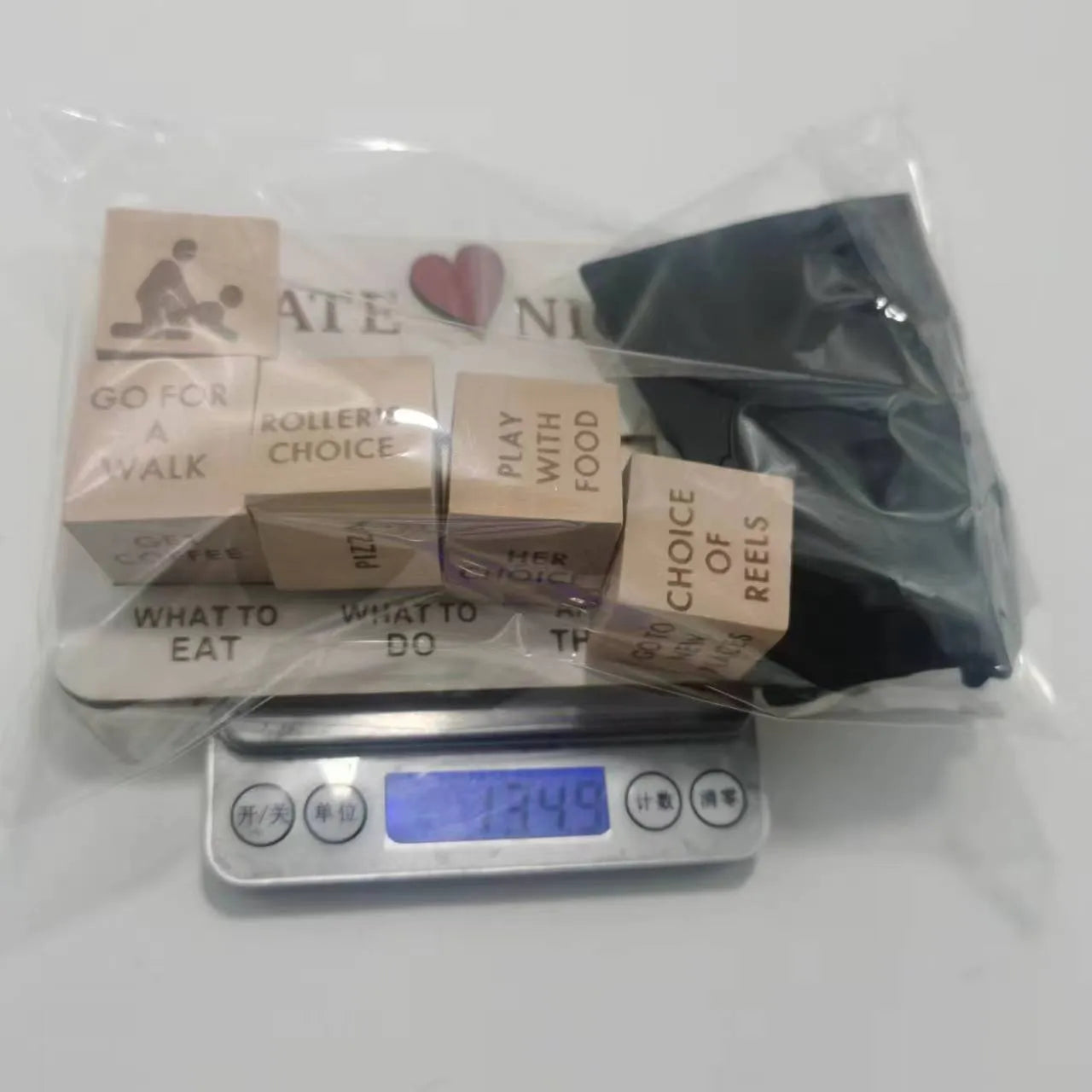 Wooden date night dice set showing five dice, planner board and black storage bag for couples