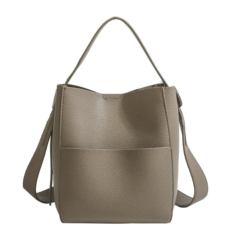 Bucket-style PU messenger bag with sewing line detail, available in black, brown, and elephant gray, on a plain background