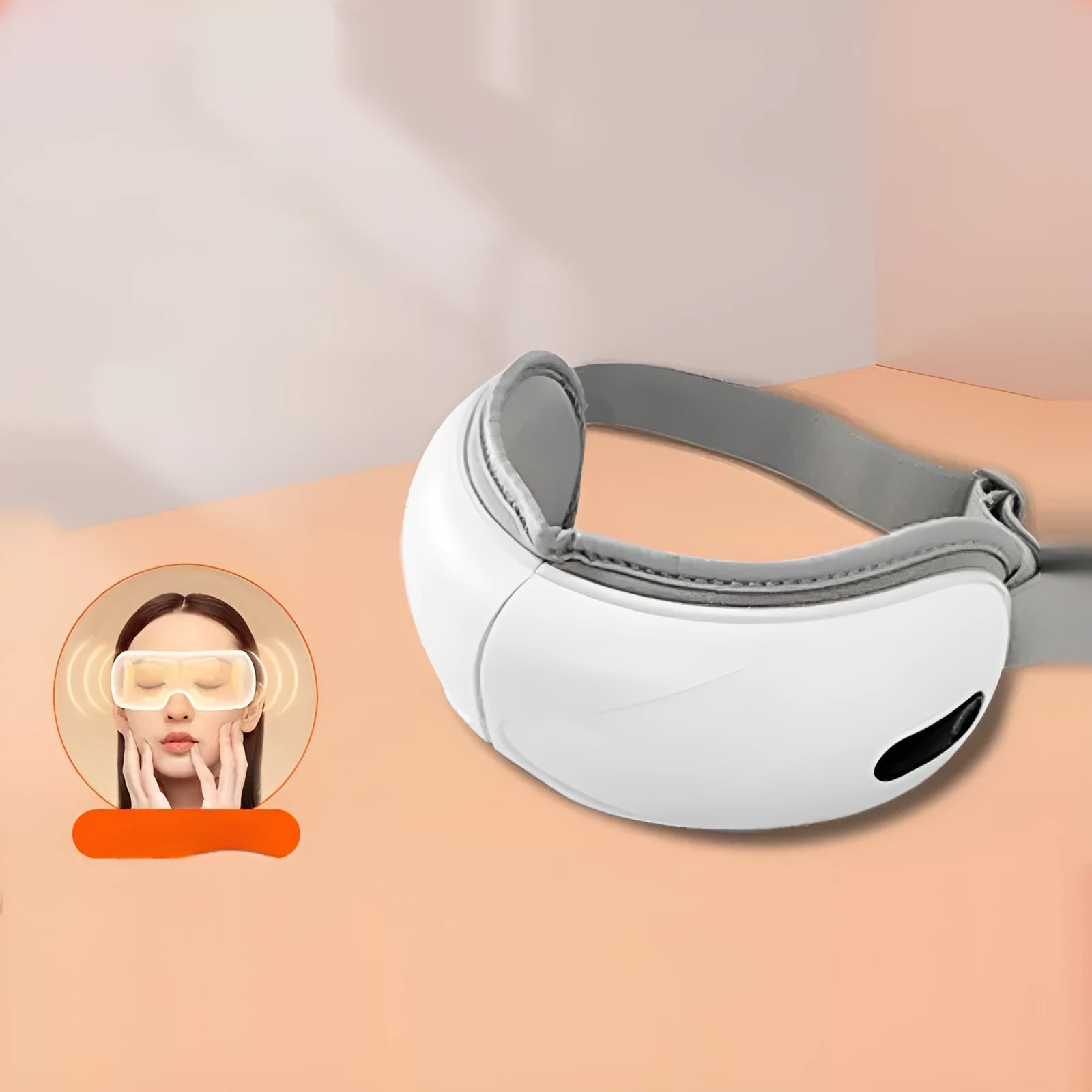 White rechargeable eye massager with hot compress and airbag massage functions on a table