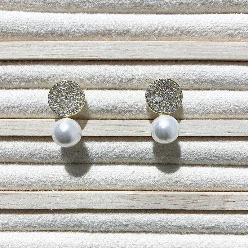 Round diamond studded pearl earrings in gold finish with post back closure