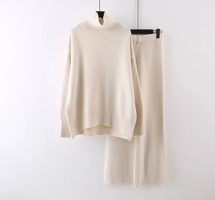 Women's milky white acrylic knit two-piece set featuring a long-sleeve sweater and wide-leg trousers on a hanger.