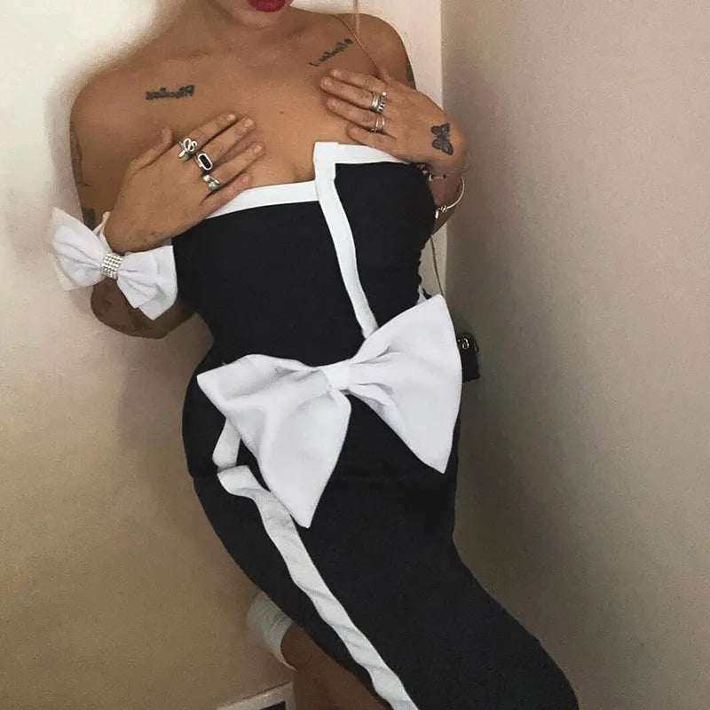 Women's black and white colour-block one-piece swimsuit with asymmetrical bow detail and tube top design