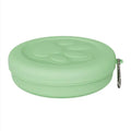 Portable dual-compartment dog feeding bowl with snack box in light green and pink colour options.