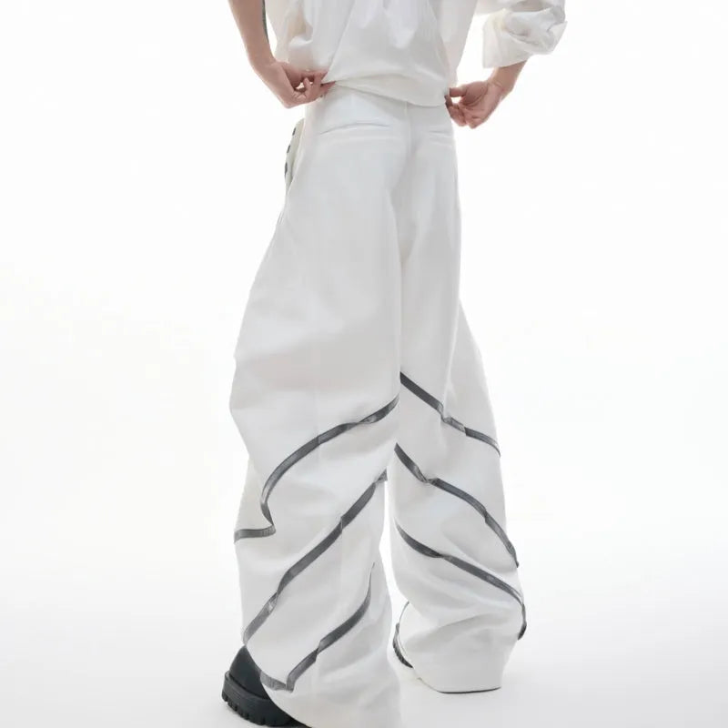 Men's black and white polyester trousers with 3D cutting, metal rivet stripes, and pleated front.