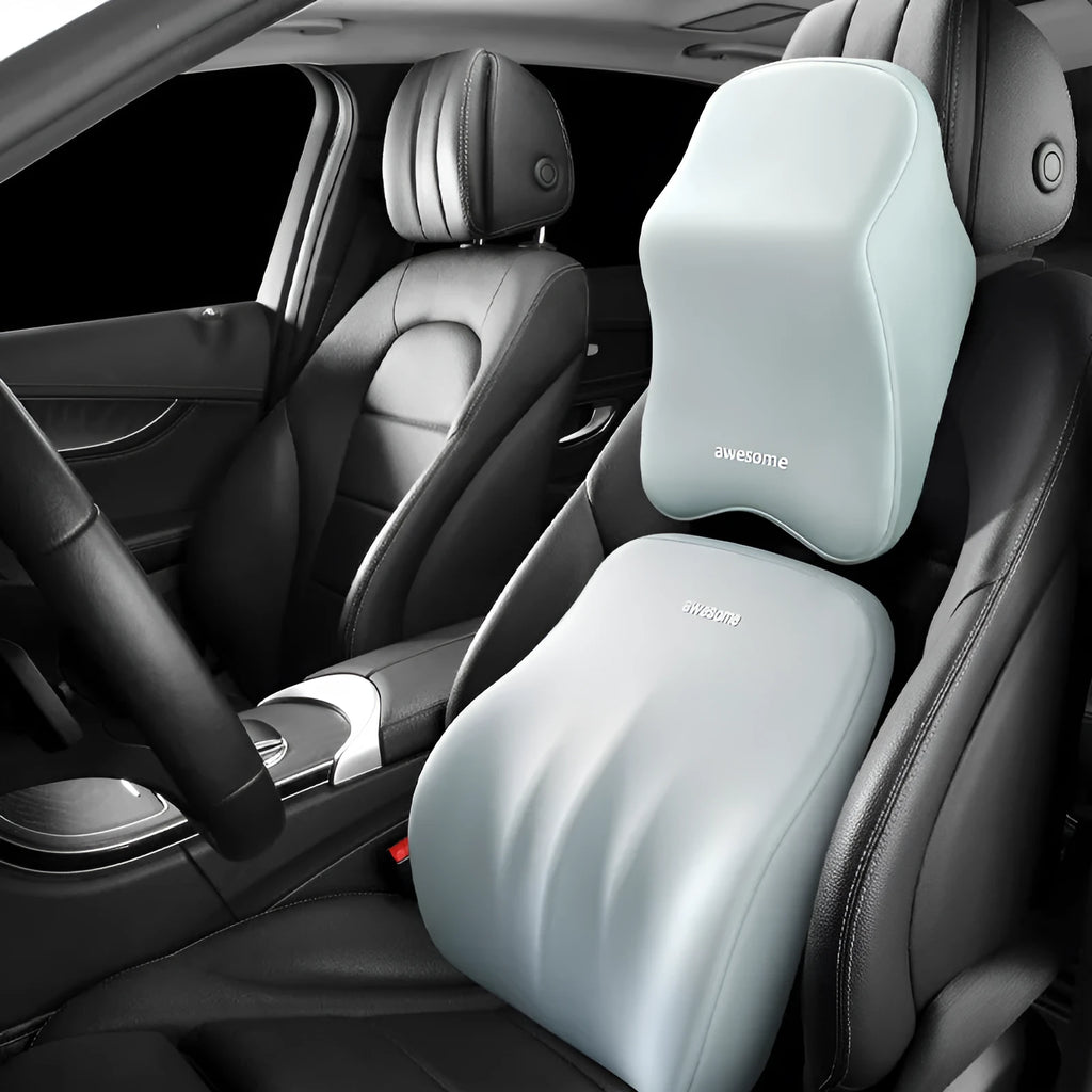 Black geometric pattern memory foam car lumbar pillow and matching headrest on a car seat.