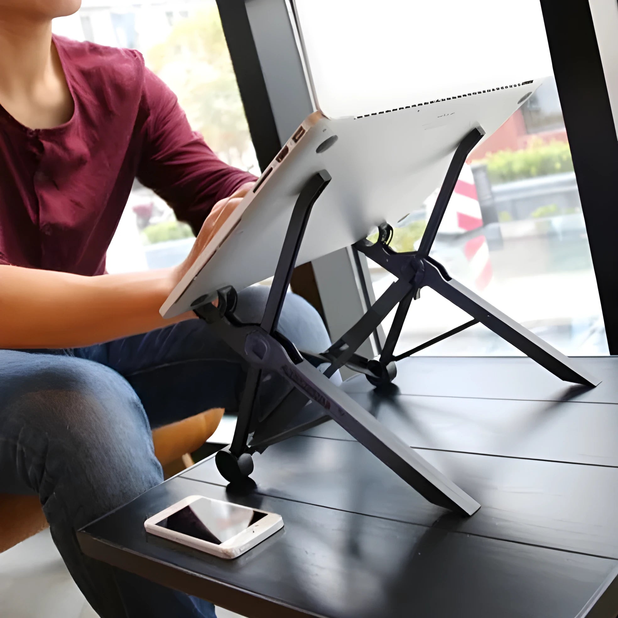 Sagacious black folding laptop bracket stand, shown unfolded to 40cm and next to its carrying case.