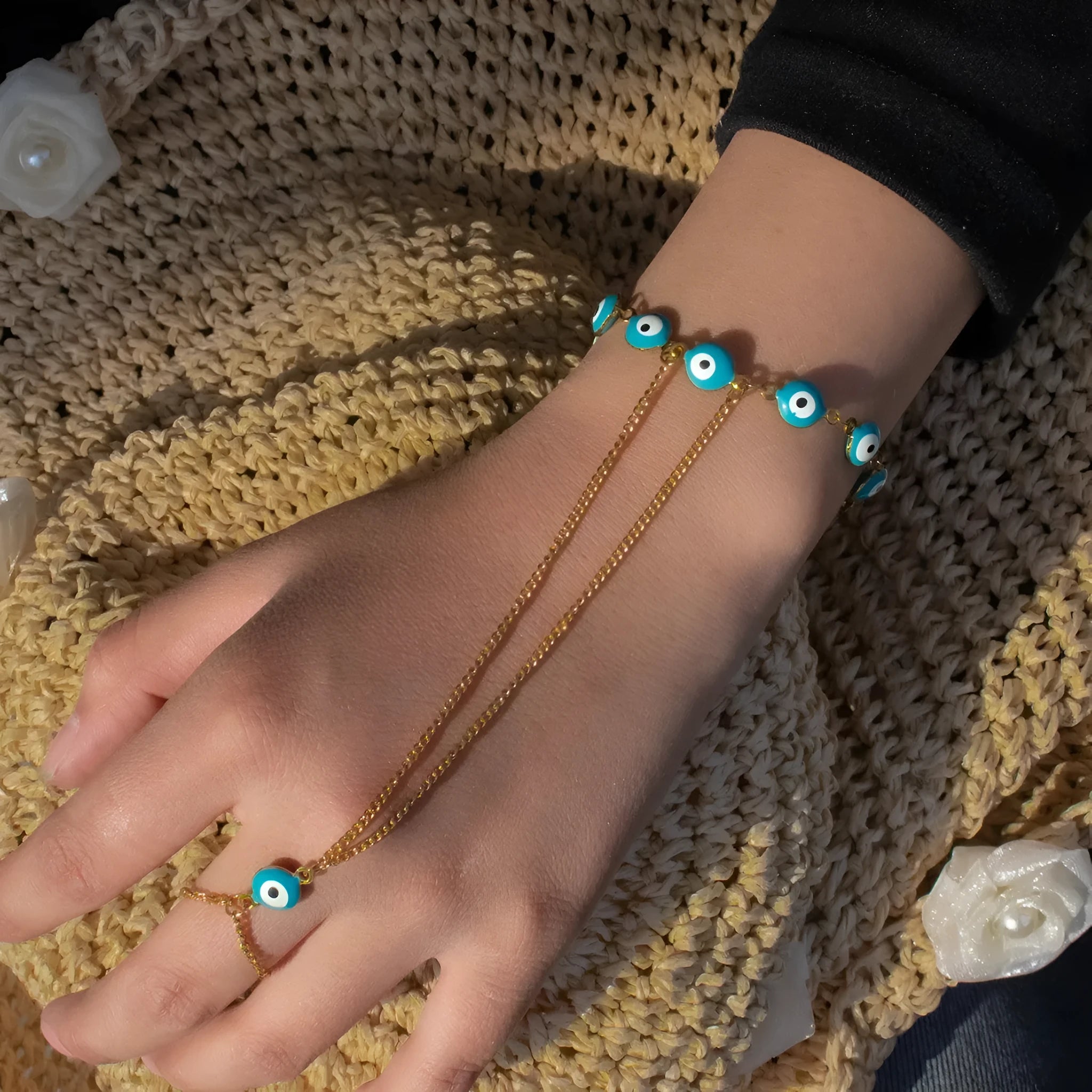 Women's titanium steel round eyes lucky mitten-type bracelet in colourful electroplated finish on a neutral background