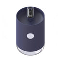 Blue wireless USB humidifier with water tank on a wooden desk next to a plant.