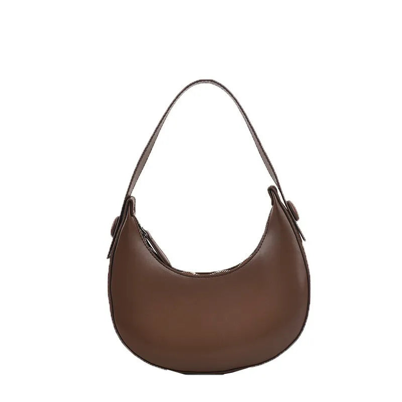 Women's retro dumpling-shaped PU shoulder bag in cream yellow with a zippered compartment.