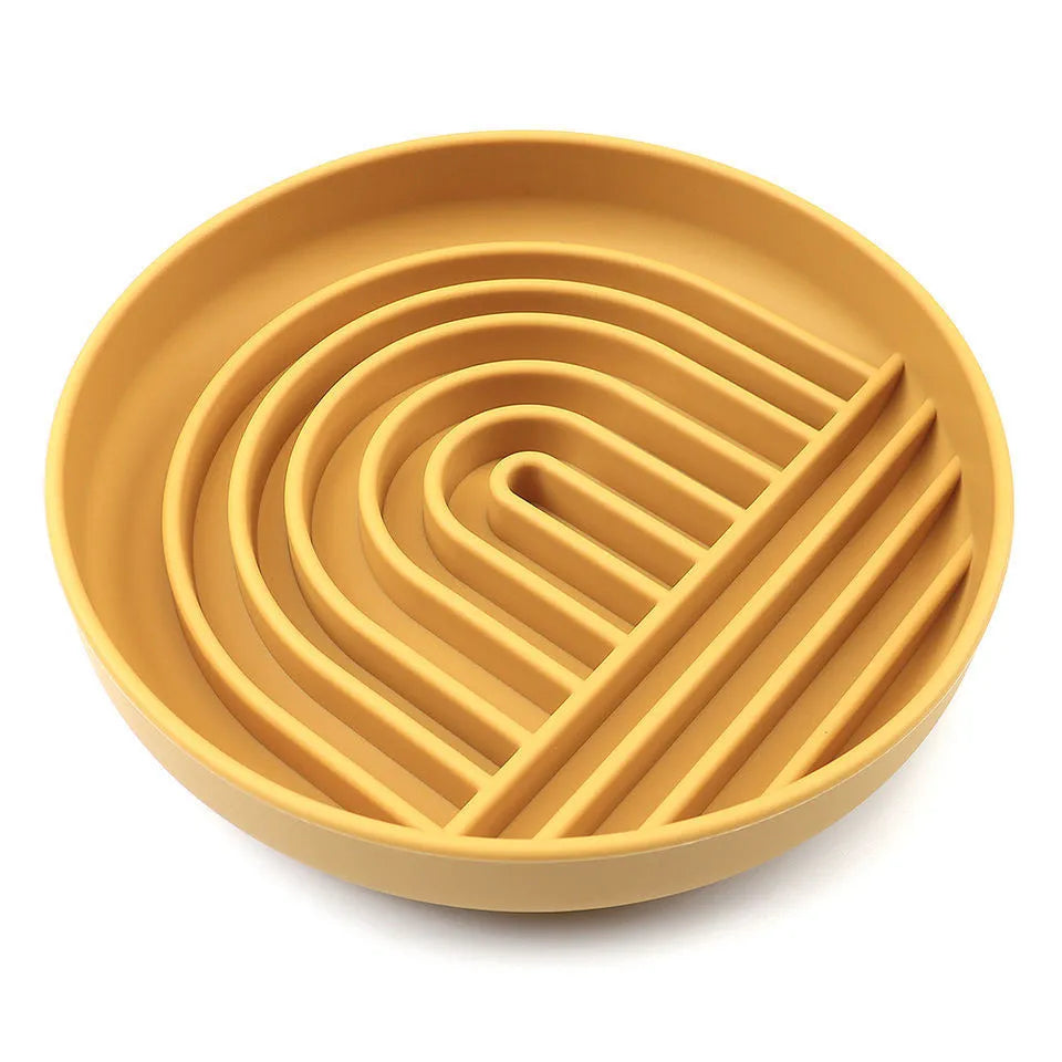Beige silicone dog slow feeder bowl with ridges, shown next to a grey blue version on a wooden floor.