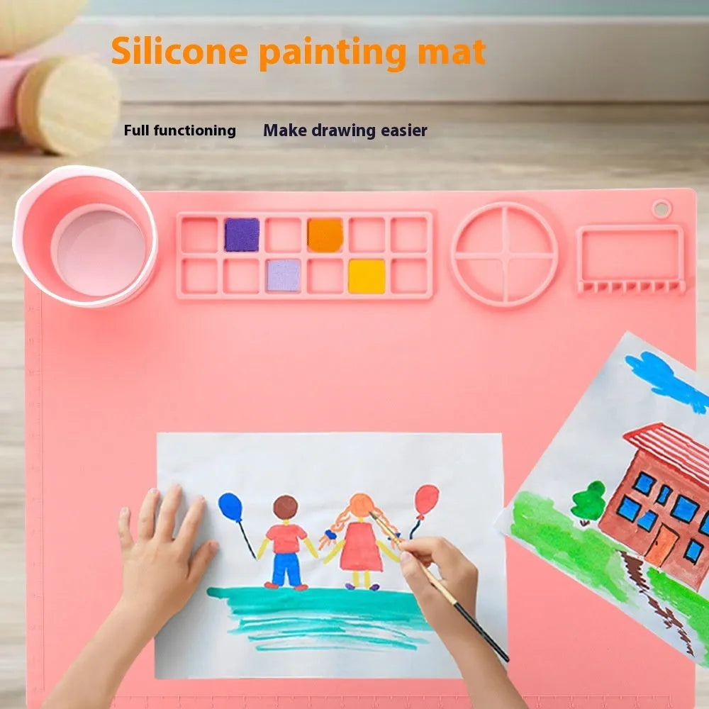 Large light blue silicone painting mat with dimensions 50cm by 40cm laid flat on a table.