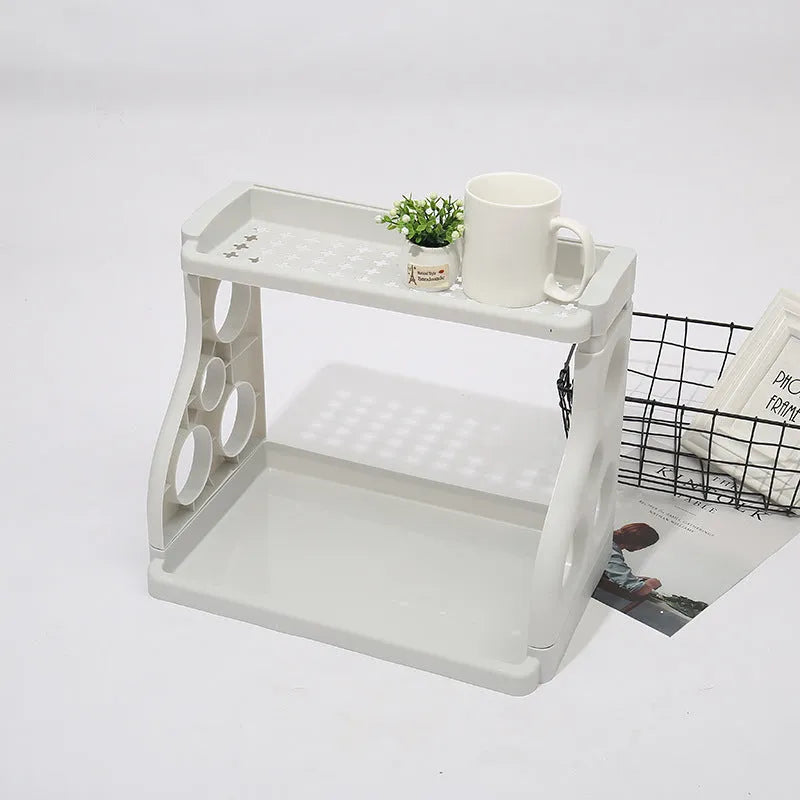 Foldable multi-layer kitchen storage rack in a choice of colours on a countertop.