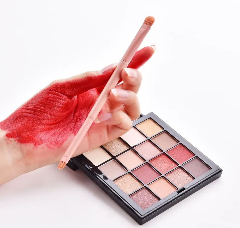 10-piece wooden handle makeup brush set including powder, foundation, eyeshadow, concealer, and lip brushes on pink background