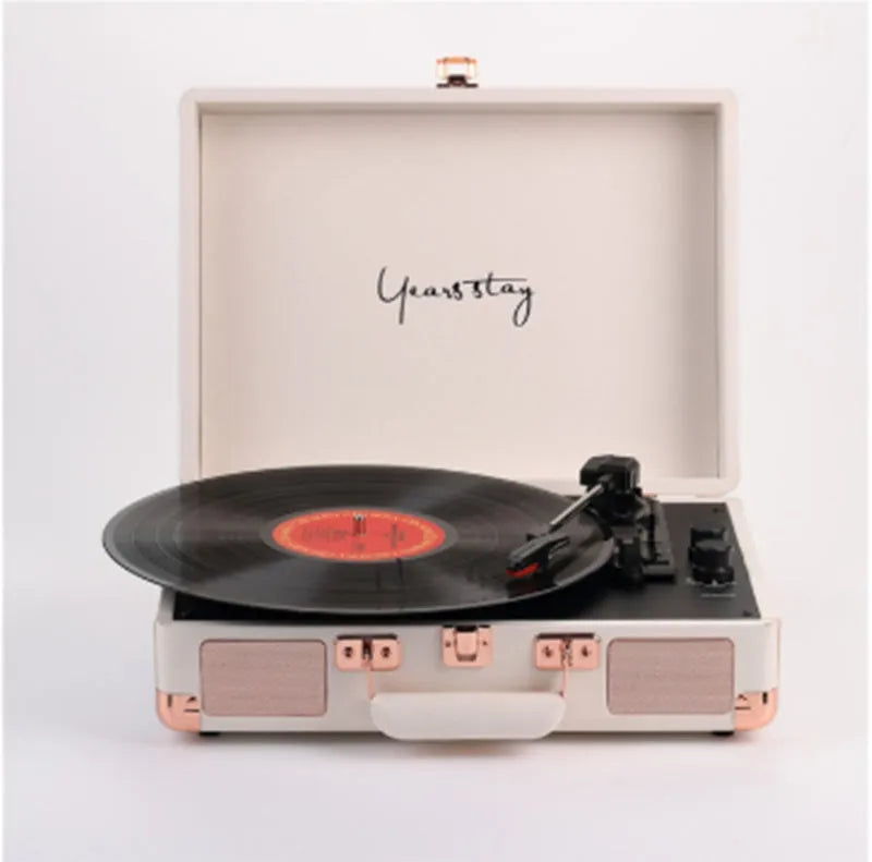 Portable Bluetooth phonograph turntable in a leather case, showing colour options.