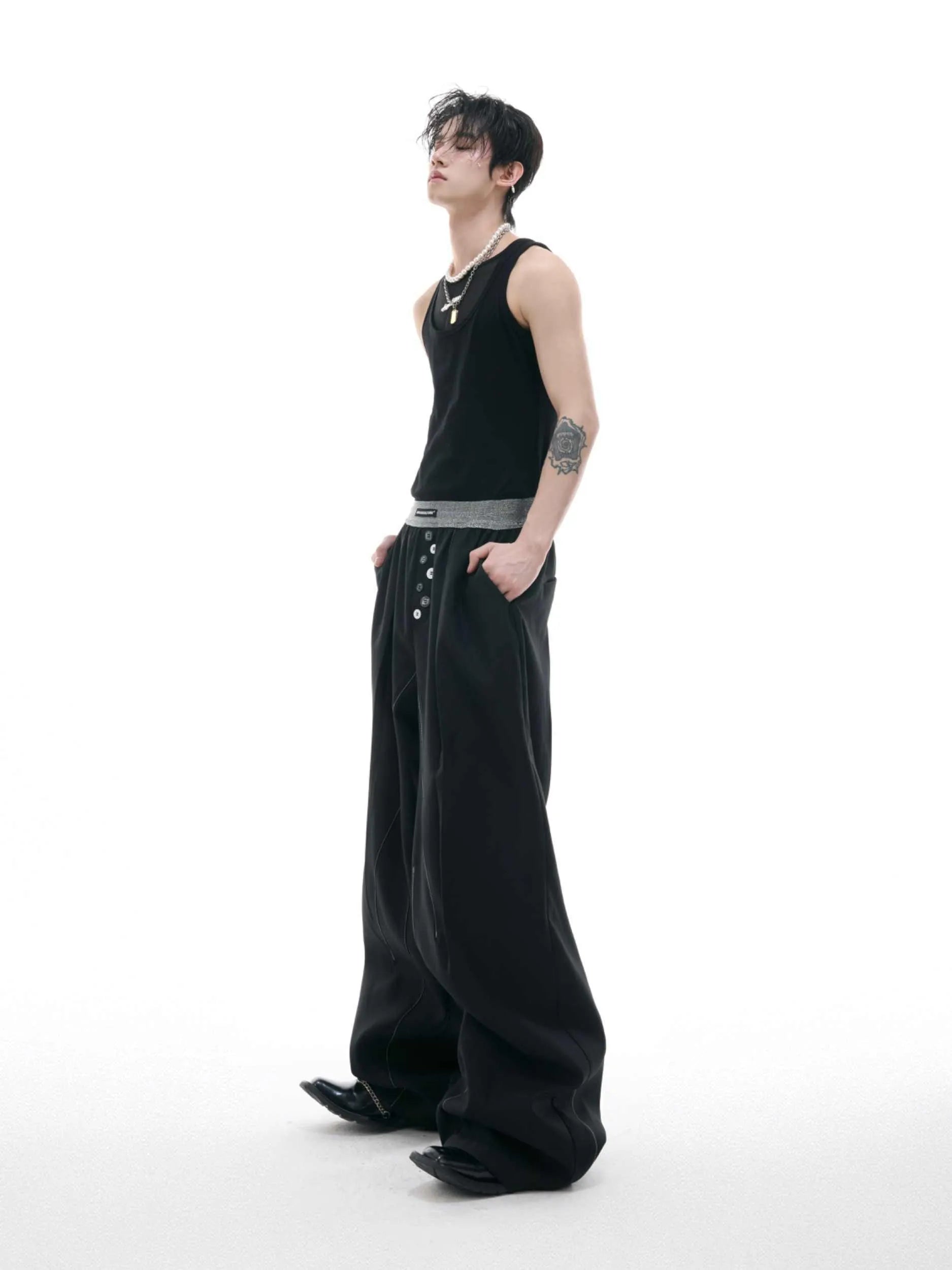 Straight-leg trousers with button-open seam design in black or grey polyester-cotton blend