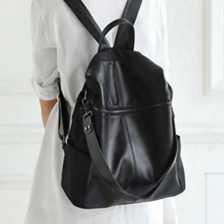 Brown genuine leather retro women's backpack with front pocket and adjustable straps.
