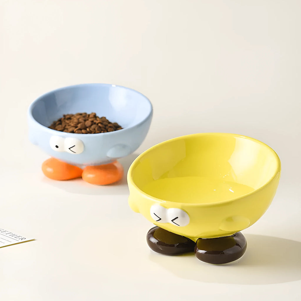 Cute Expression tall slanted ceramic pet food bowl in blue and yellow colours for cats and dogs