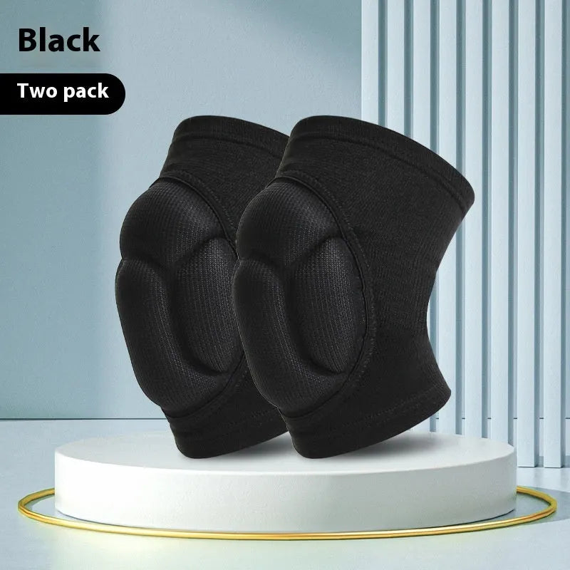 Black and blue pair of thick sponge knee pads for sports protection on a neutral background.