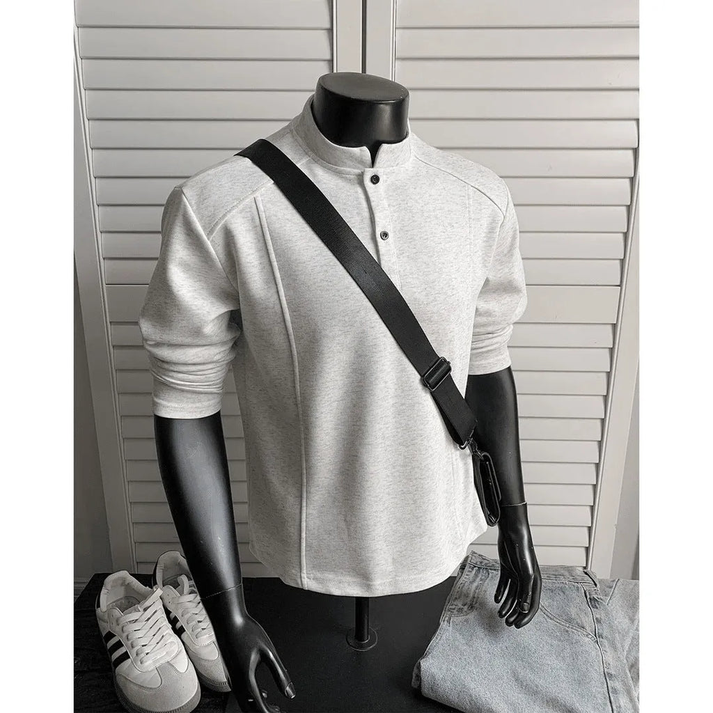 Men's loose-fit long sleeve polo shirt with an asymmetric design and stand-up collar in grey.