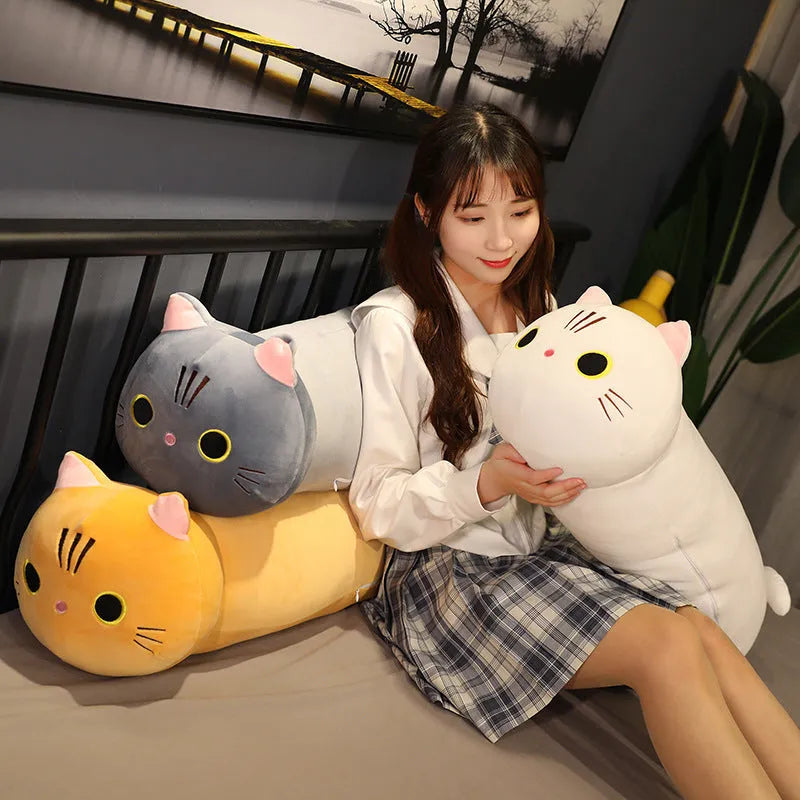 Large grey cat plush toy pillow on a sofa showing its soft texture and size.