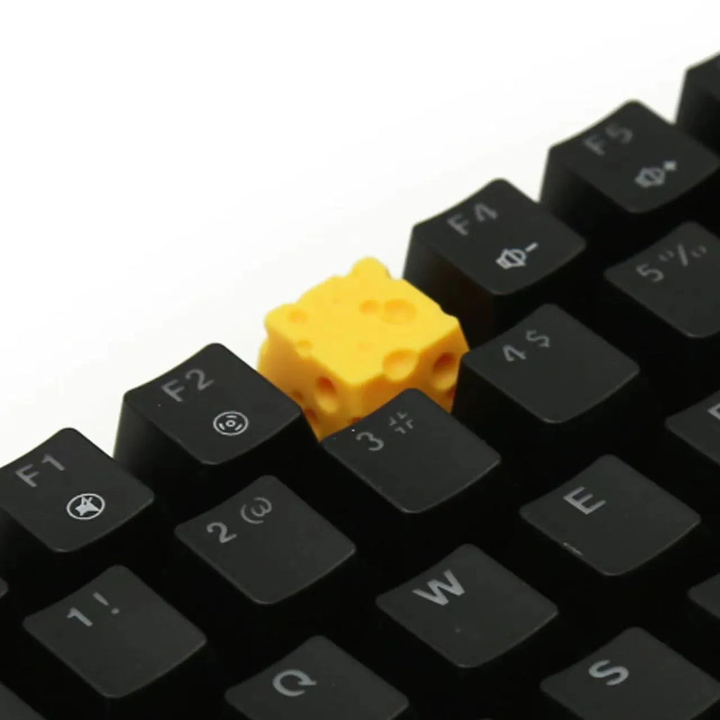 Yellow solid resin cheese wedge keycap for MX mechanical keyboards.