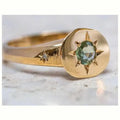 Gold colour adjustable ring with a star-shaped zircon stone set flush into an oval zinc alloy band.