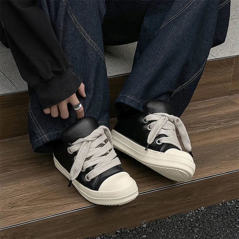 Men's black leather slip-on casual shoes with flat rubber sole and round toe.