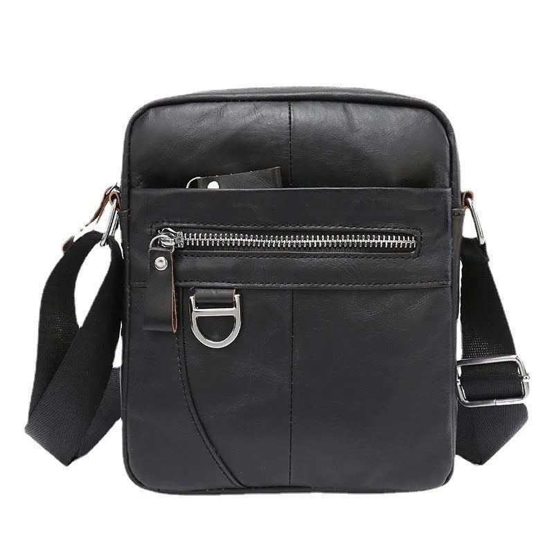Retro brown leather messenger bag with crossbody strap on a table.